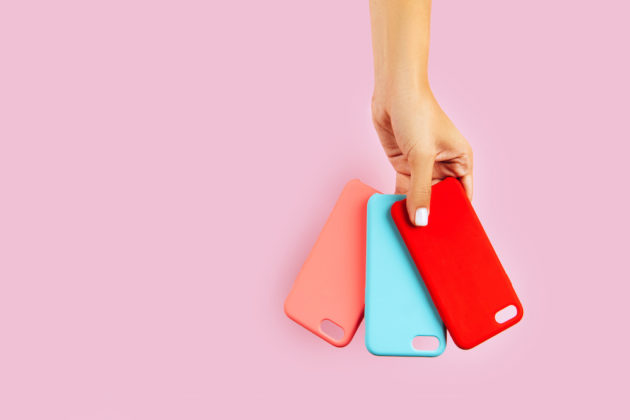 hands holding colorful smartphone cases